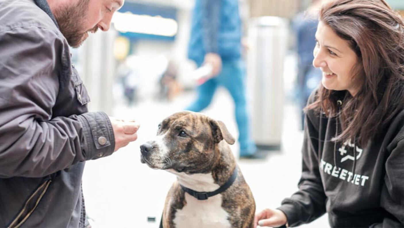 Outreach works talking to dog on the street